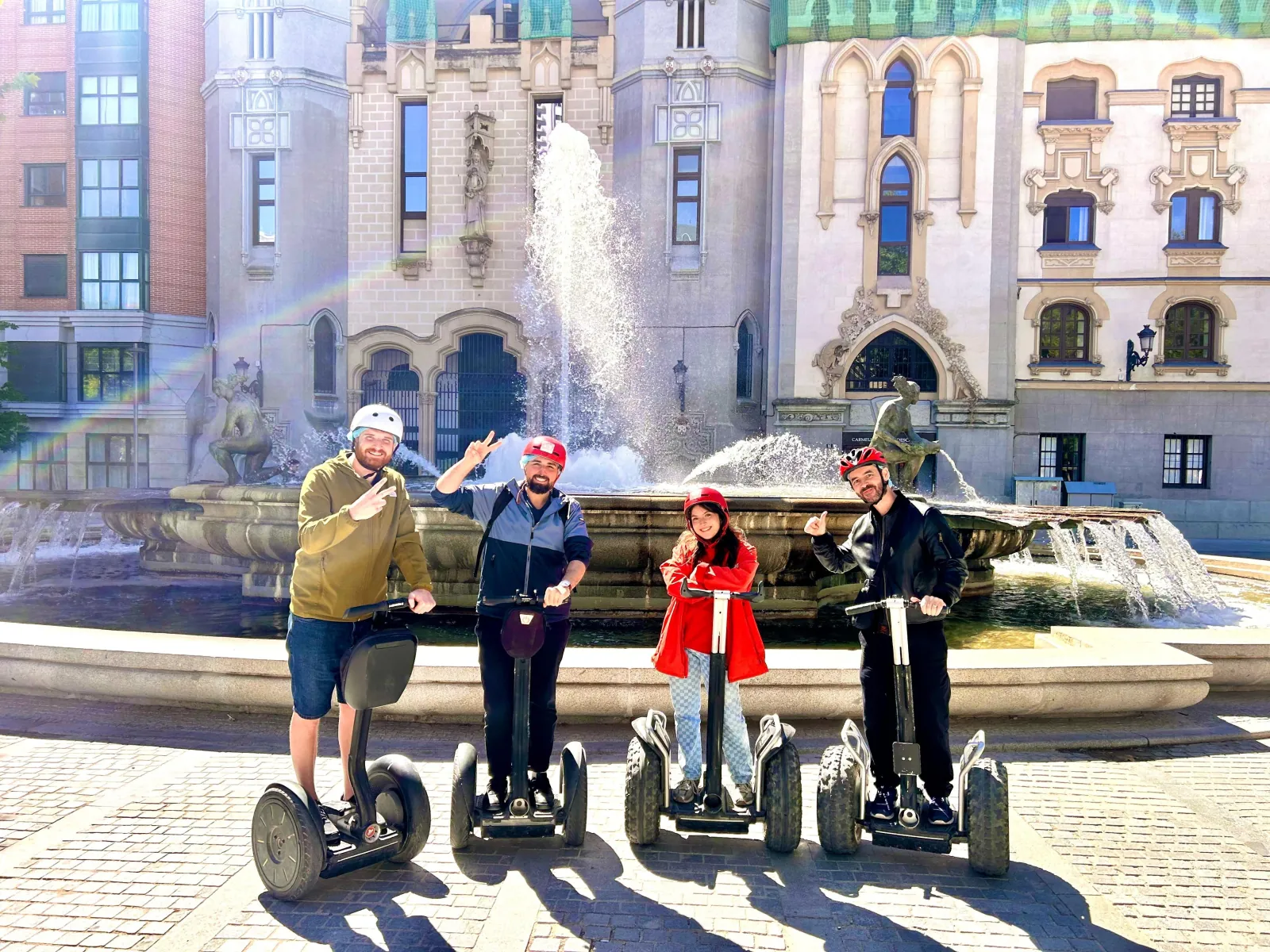 Segway riders beside a fountain in central Madrid