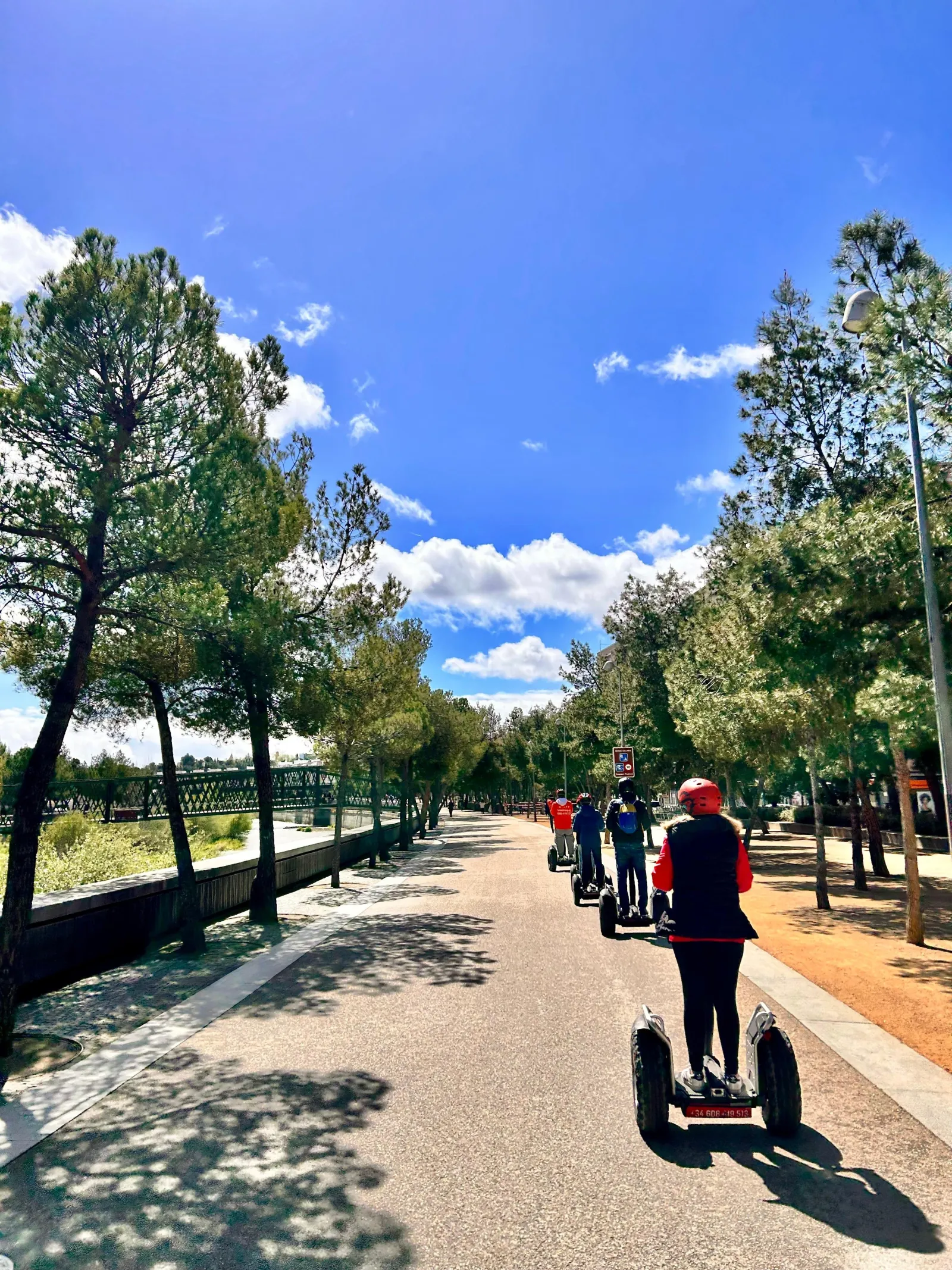 Segway riders on the tree-lined Madrid Río promenade