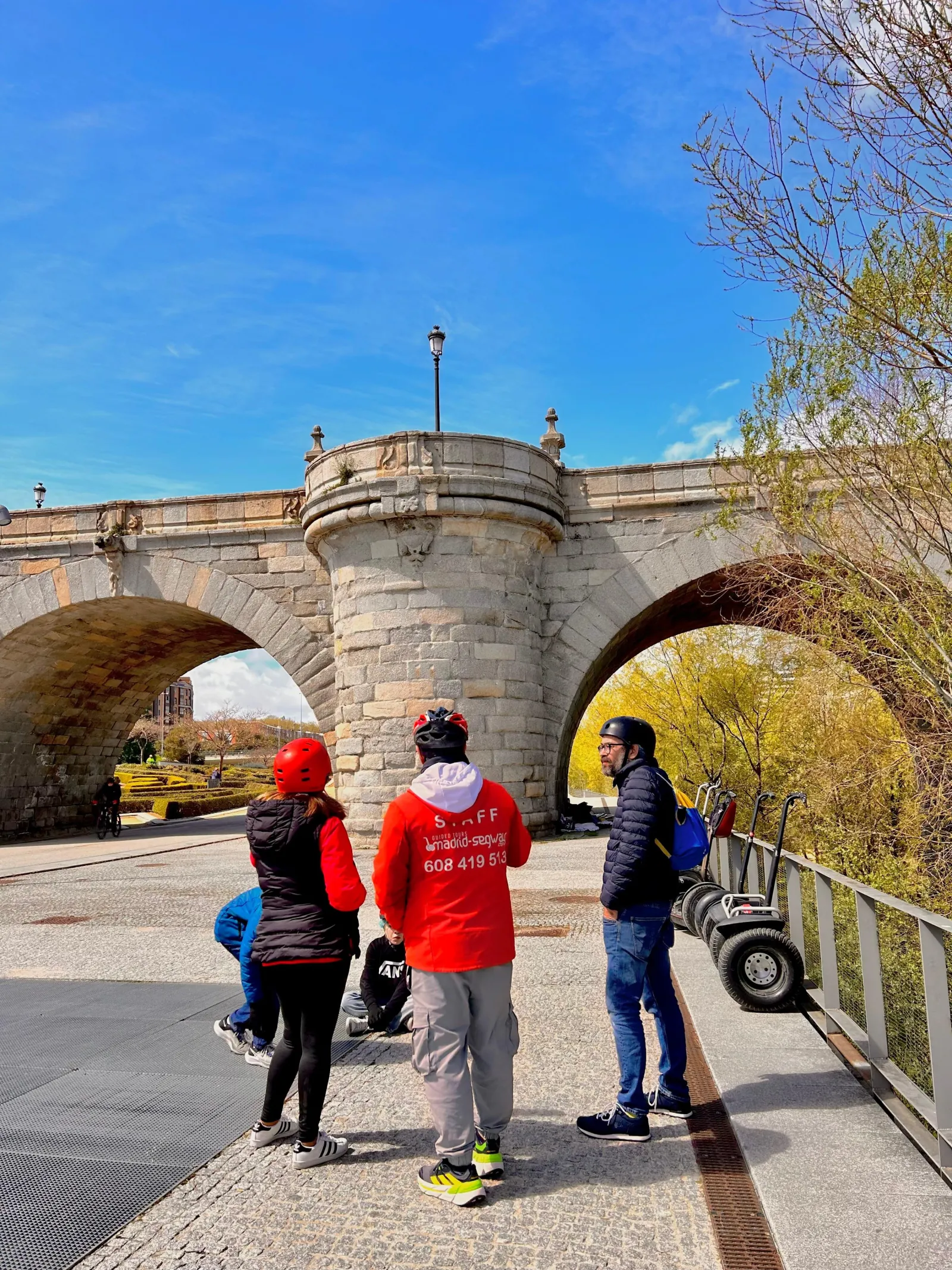 Riders on Segways at a bridge over the Manzanares in Madrid