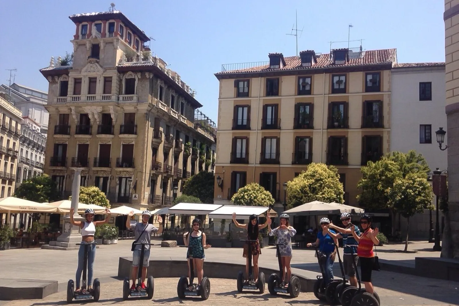 Segway group in a Madrid square lined with café terraces