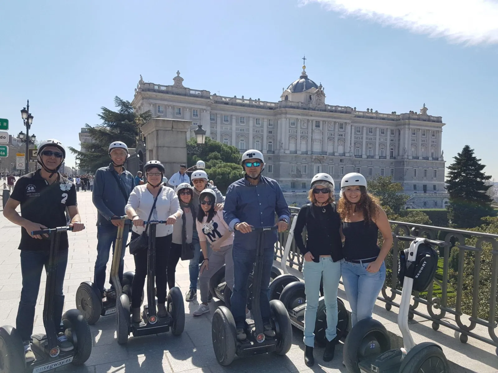 Riders on Segways in front of the Royal Palace of Madrid