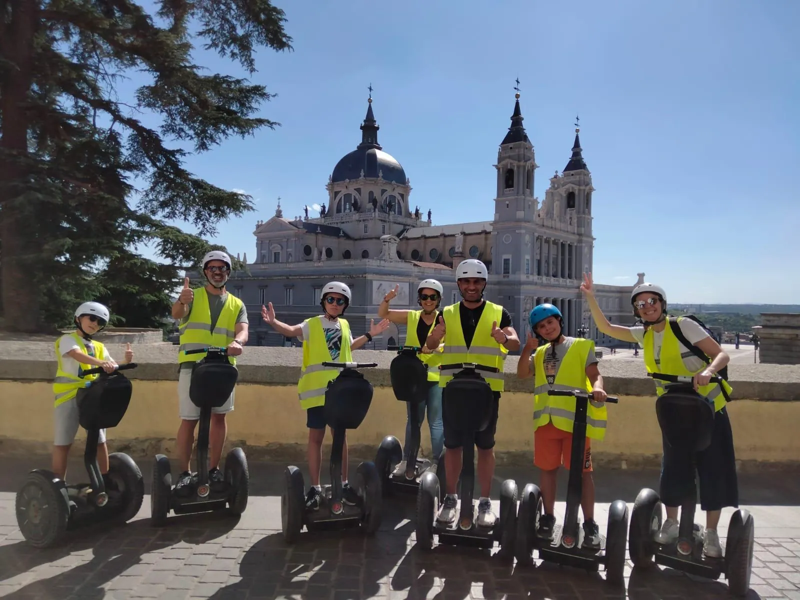Riders in hi-vis vests on Segways below the Almudena Cathedral
