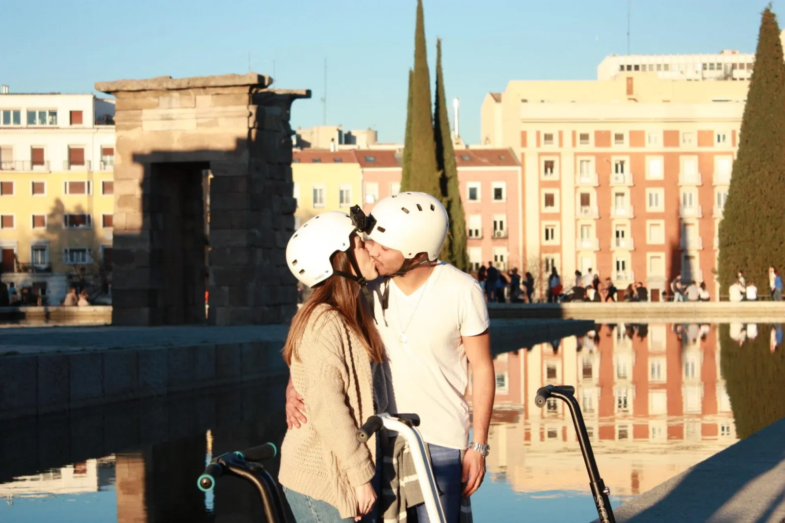 Two riders on Segways at the Templo de Debod at sunset