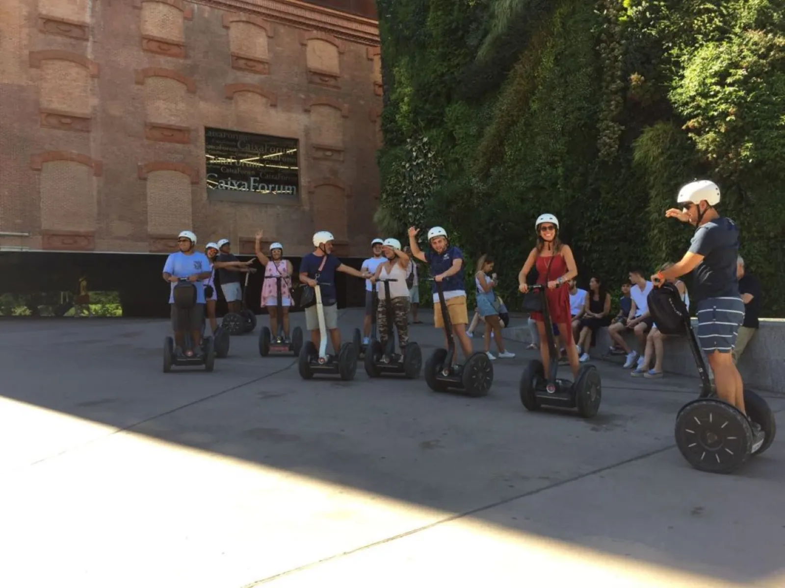 Segway riders beside a stone monument in Madrid