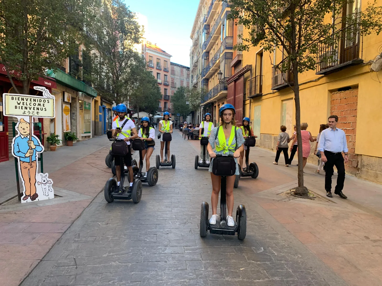 Segway riders on a Madrid street at dusk