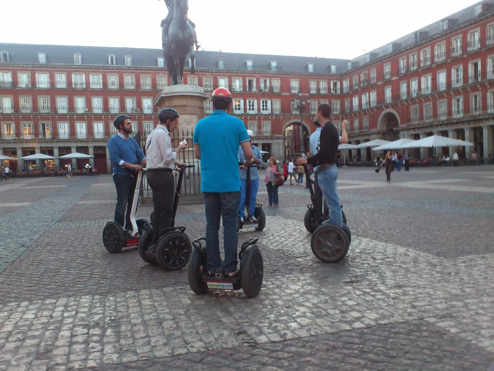 Riders on Segways on the cobbles of Plaza Mayor, Madrid