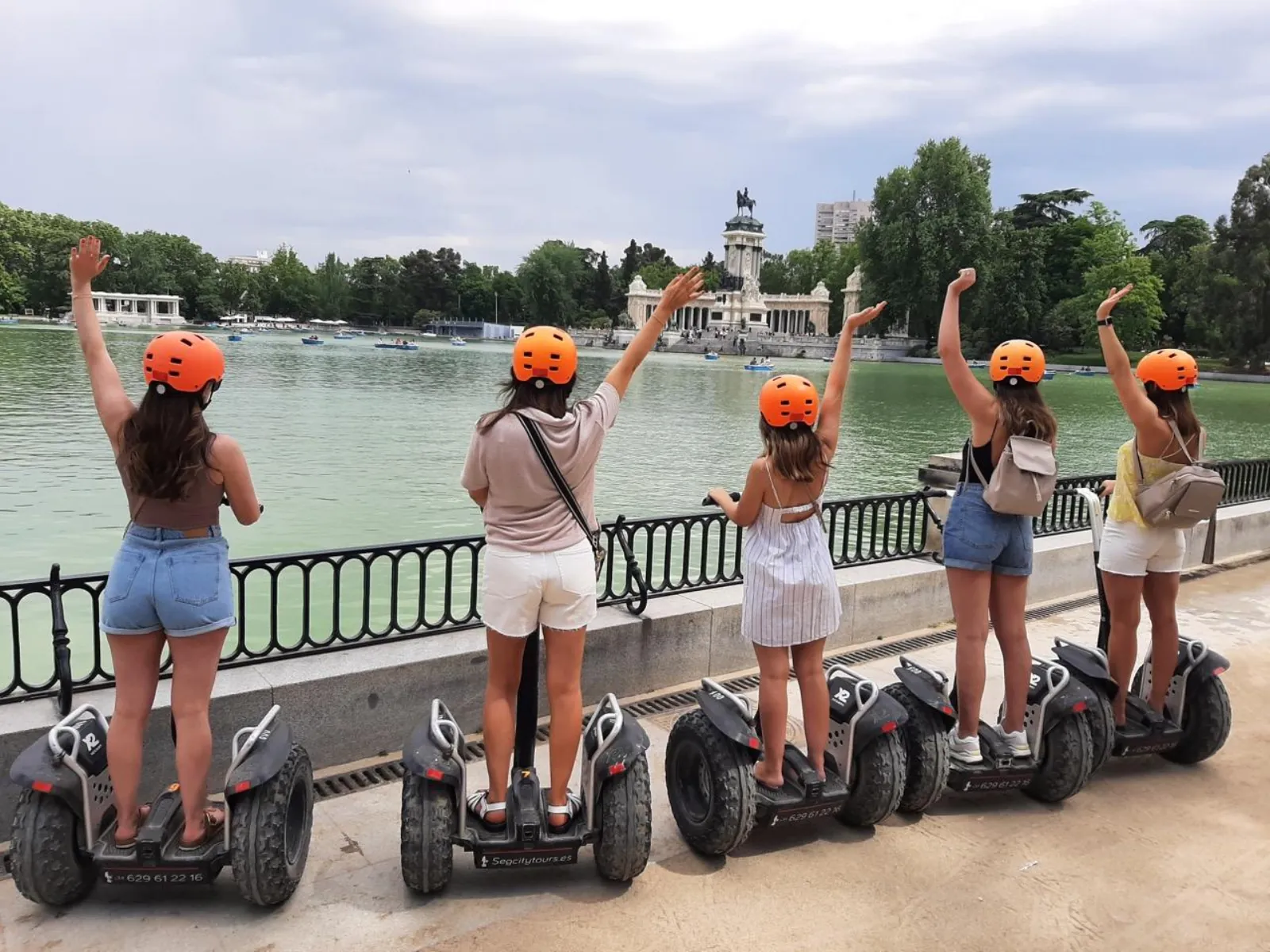 Two riders on Segways beside the Retiro lake in Madrid