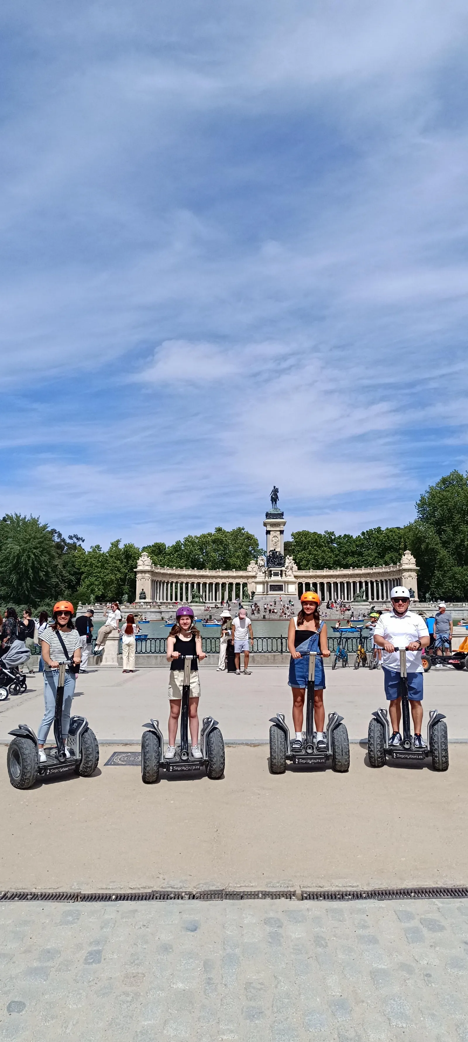 Riders on Segways below the Alfonso XII monument in Retiro Park