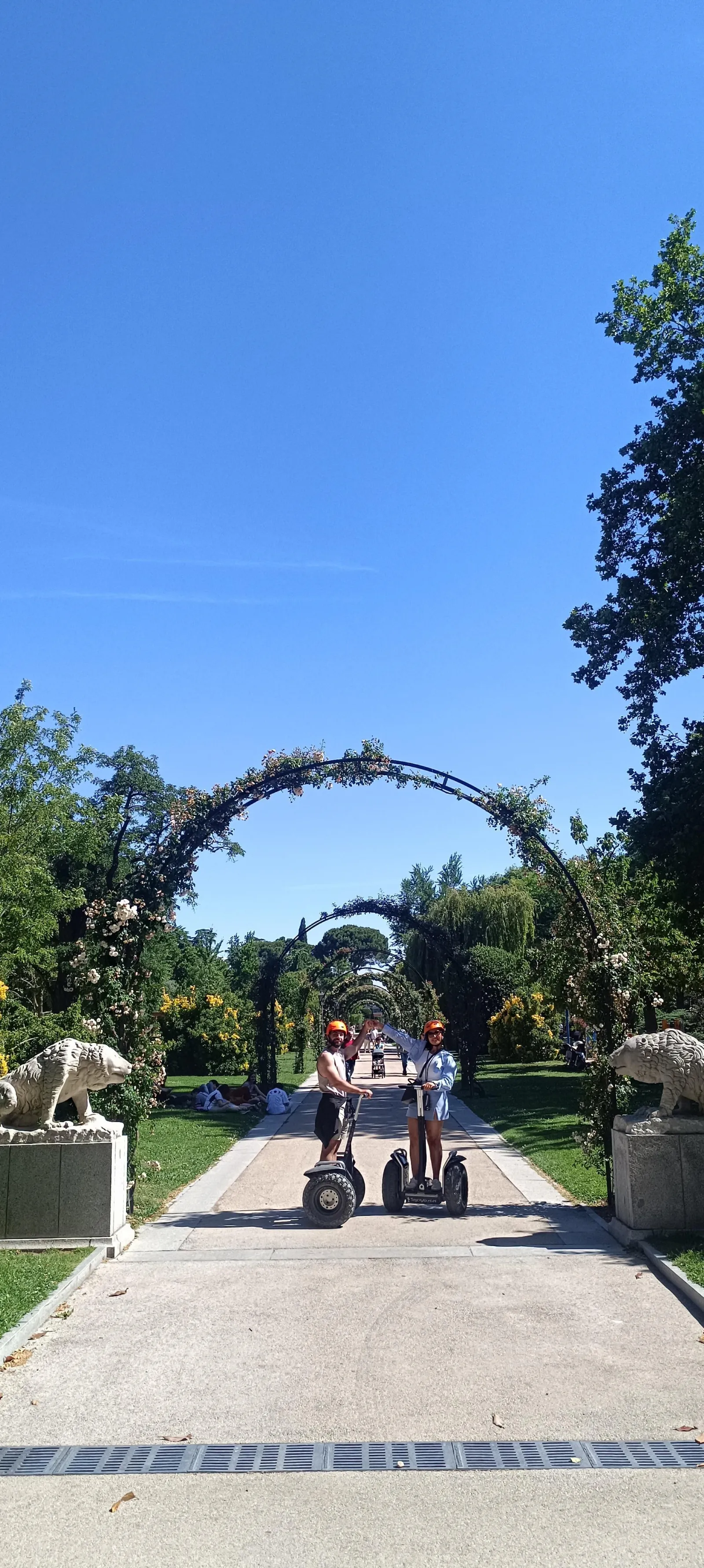 Segway riders under the rose arbour in Retiro Park