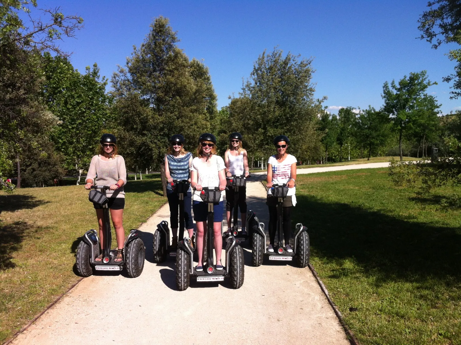 Riders on Segways on a Casa de Campo track in spring